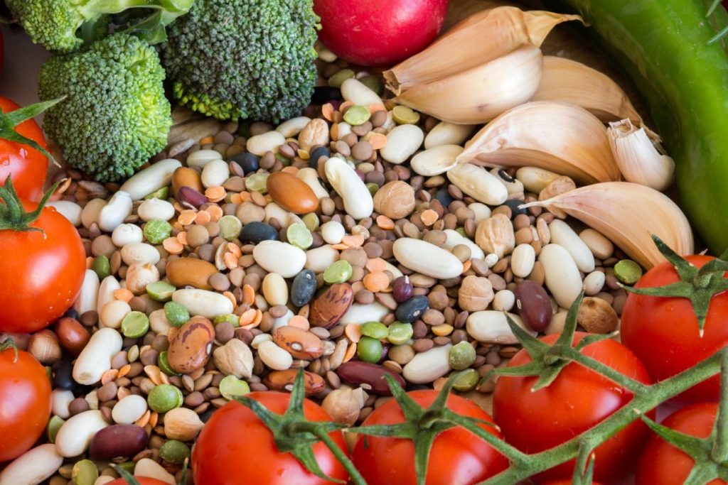 Mixed legumes and vegetables on a wooden table